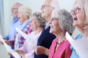 A group of elderly people singing in a choir