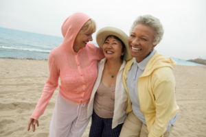 Three women smiling on the beach